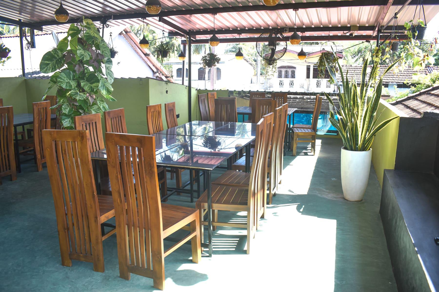 Rooftop Corner — Hanging lanterns and greenery on the top floor at Food Cabin Galle