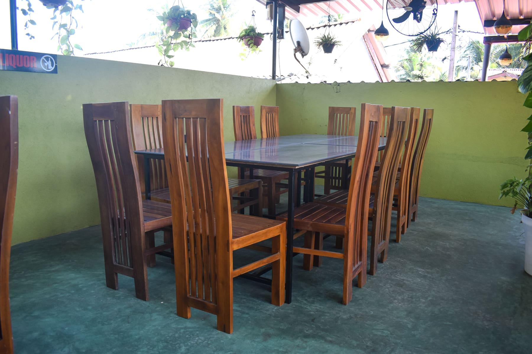 Open-Air Family Seating — Room for the whole family under the palms at Food Cabin Galle