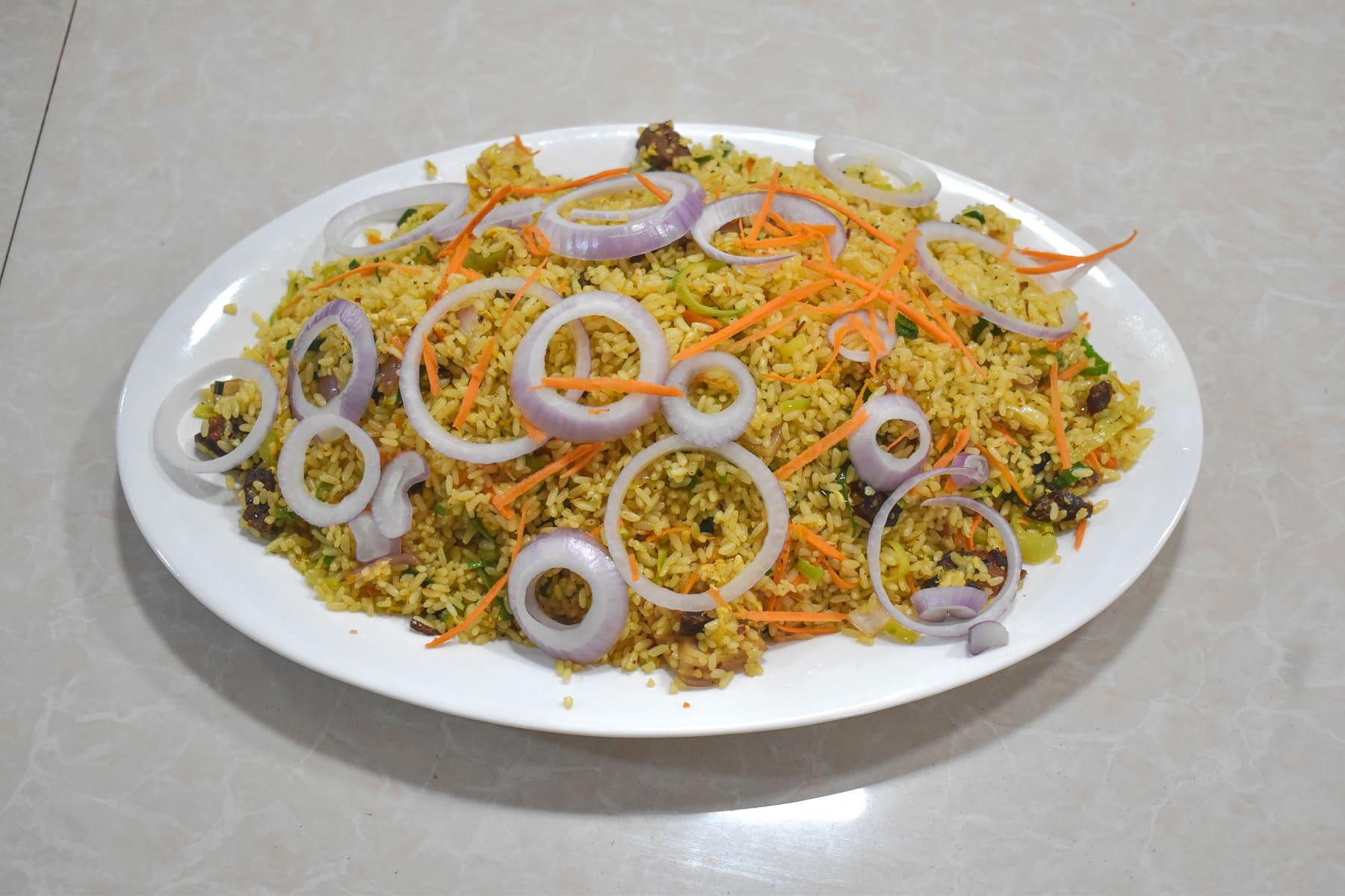 Special Fried Rice Platter — Plated and topped with fresh onion rings at Food Cabin Galle
